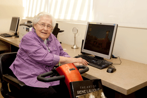 Woman in front of computer at Beatitudes campus.