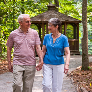 Man and woman walking out doors on Lake Prince campus